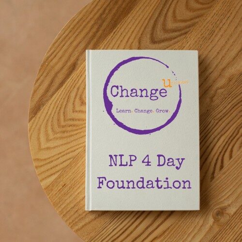 White note book on wooden table - NLP 4 day Foundation Course Manual