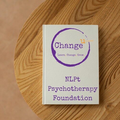 White note book on wooden table - NLP Pyschotherapy Foundation Course Manual